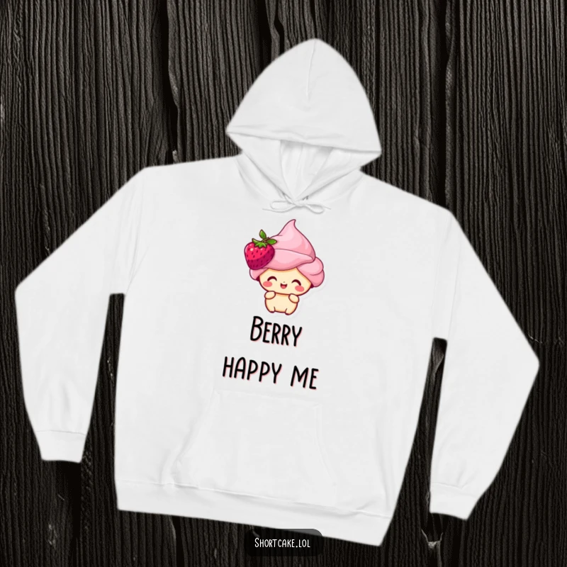 Funny shortcake character with a berry on its head, looking happy, featured on a soft, warm hoodie.