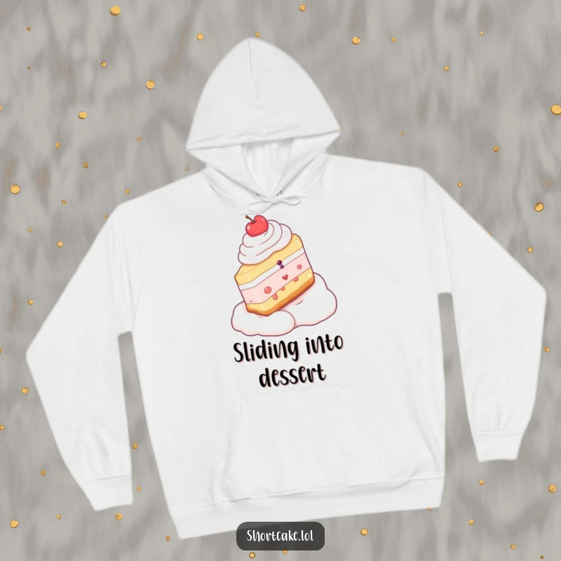 Funny hoodie graphic of a shortcake slice gleefully sledding down a fluffy whipped cream slope, perfect for cozy laughs.