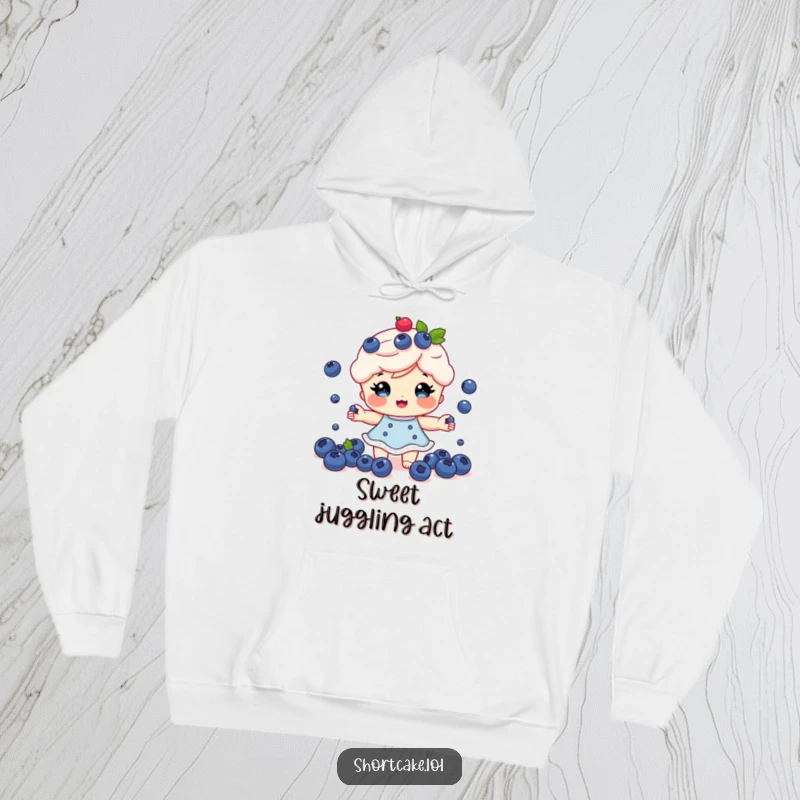 Funny Shortcake Hoodie: A shortcake character juggling multiple tiny blueberries with a happy expression, great for comfort.